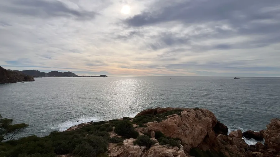 Rocky coastline and the Mediterranean against the light near Barcelona